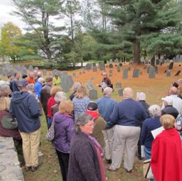 Cemetery tourgoers looking out across cemetery.